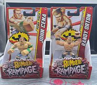 Front view of both sealed WWE Rumblers Rampage figures
