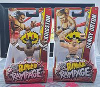 Front view of both sealed action figures in packaging