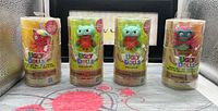 Four sealed Hasbro UglyDolls figures in cylindrical packaging