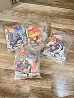 Four sealed Lowe’s Build & Grow Marvel superhero wood kits in original packaging on floor