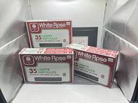 Front view of three boxed White Rose 35-light sets
