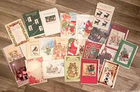 Assorted unused Christmas cards laid out showing variety of designs and captions