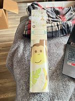 Front view of sealed tube showing monkey decal and packaging label