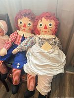 Front view of both Raggedy Ann & Andy dolls seated