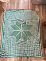 Full view of green gingham tablecloth with star design