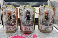 Front view of three boxed figures showing characters