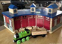 Roundhouse, Oliver engine, and cake cargo car displayed on tabletop