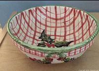 Top view showing red plaid interior and holly motif