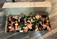 Open cardboard box filled with fall themed floral picks