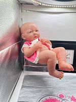 Full view of Berenguer preemie doll reclining, shows size and clothing