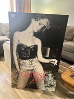 Front of Guess Jeans advertising sign showing full image and logos