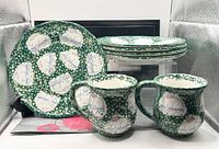 overview of four plates and two mugs showing matching bunny spongeware pattern