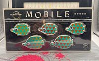 Front view of sealed 1960s fish mobile on display card