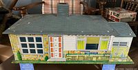 Front exterior of lithographed tin dollhouse