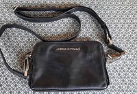 Front view showing entire purse, strap, and logo