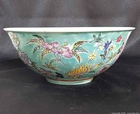 Side view showing turquoise ground and multicolour floral decoration