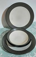 Front view showing dinner plate and bowl stack displaying pattern