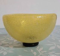 side view showing yellow mottled exterior and black base