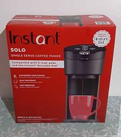 Front of sealed box displaying Instant Solo coffee maker