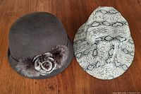 Front view of both hats showing overall style, colors, trim