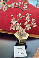 Front view of gemstone bonsai tree showing blossoms, leaves, trunk, and brass planter