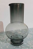 Full view of smoked gray glass carafe showing overall shape and color