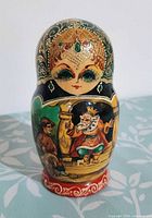 Largest nesting doll showing king on throne artwork and signature area