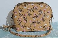 Front view of floral Steve Madden crossbody bag with strap