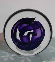 Front view showing purple swirl inside clear glass