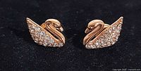 Front view of both swan earrings showing rose gold plating and pavé crystals