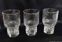 Three Iittala Aslak ice-textured juice glasses, front view