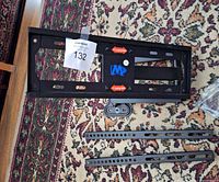 Front view of main wall plate, mounting rails, hardware bag visible