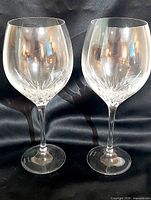 pair of clear crystal Duchess wine goblets standing side by side