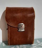 Front view of leather binocular case, clasp visible