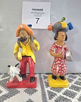 Front view of both clay figurines showing overall condition and colours