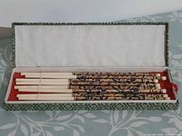 Box open showing eight chopsticks