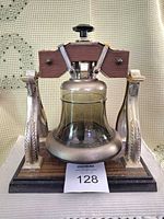 Front view of Liberty Bell decanter on swinging stand