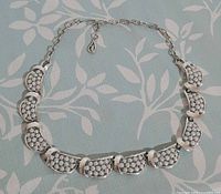 Full view of silver-tone Coro choker laid flat showing all scalloped links and adjustable chain