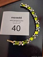 Front view of bracelet showing green glass and AB rhinestones