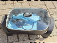 Overall view of Black & Decker electric skillet with lid and control probe inside