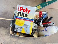 Box top view showing Poly Filla carton, roller frames, tape, filler tools