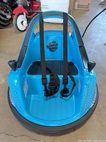 front view of blue Bumper Buddy ride-on bumper car showing harness and logo
