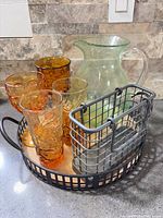 Full lot: four amber glasses, green pitcher, tray, caddy