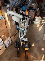 Full view of folded exercise bike showing frame, seat, handlebars and base