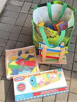 Group shot showing bag of foam blocks, wooden slats in rack, boxed Little Tikes counting worm, and wooden shape puzzle tray