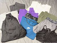 Overview of all nine clothing items on bed