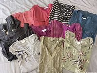 All 11 tops laid out showing colours and styles