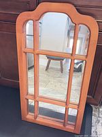 Front view of wooden arched six-pane mirror