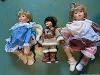 All three porcelain dolls side by side