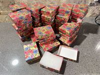 Stacked floral print jewelry boxes, one open showing cotton insert